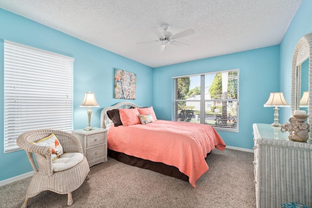 carpeted bedroom featuring a textured ceiling and ceiling fan