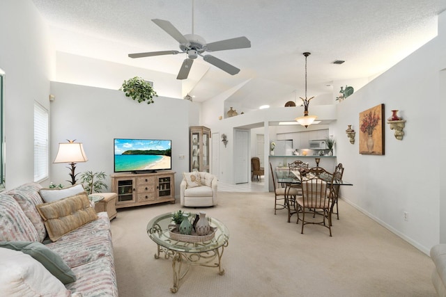 carpeted living room featuring high vaulted ceiling and ceiling fan