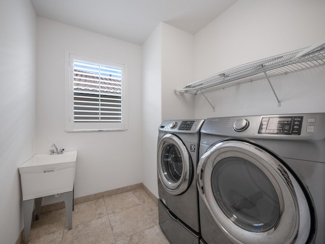 clothes washing area featuring independent washer and dryer and light tile patterned floors