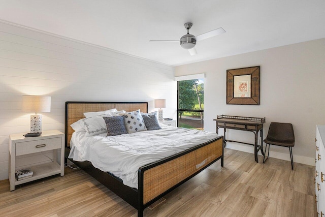 bedroom with light wood-type flooring, a ceiling fan, and baseboards