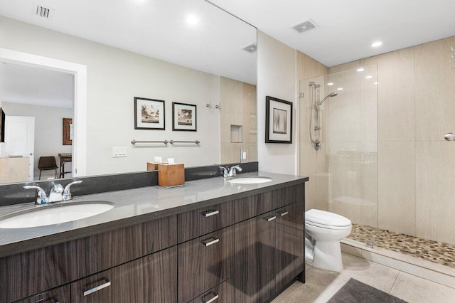 full bathroom featuring tiled shower, a sink, and visible vents