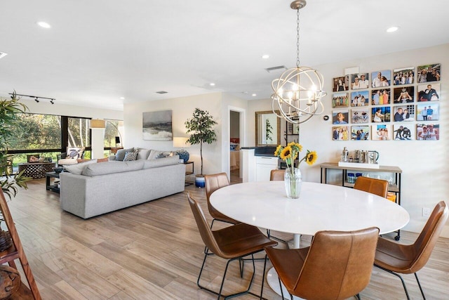 dining space with light wood-type flooring, visible vents, a chandelier, and recessed lighting