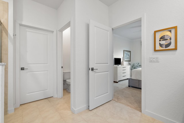 hallway featuring light colored carpet