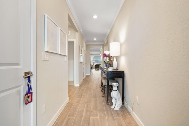 corridor featuring light hardwood / wood-style floors and crown molding