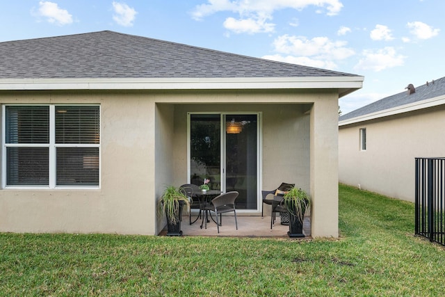 rear view of house featuring a patio and a lawn