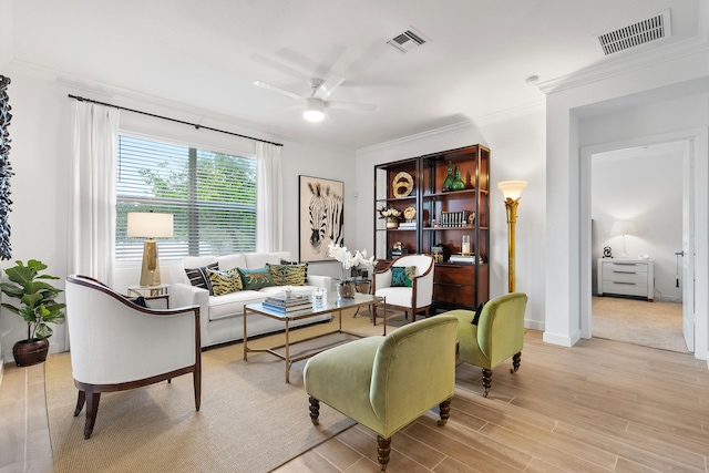 living room with ceiling fan, light hardwood / wood-style floors, and ornamental molding