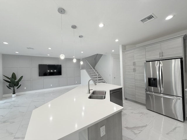 kitchen with stainless steel fridge, sink, a large island with sink, pendant lighting, and dishwasher