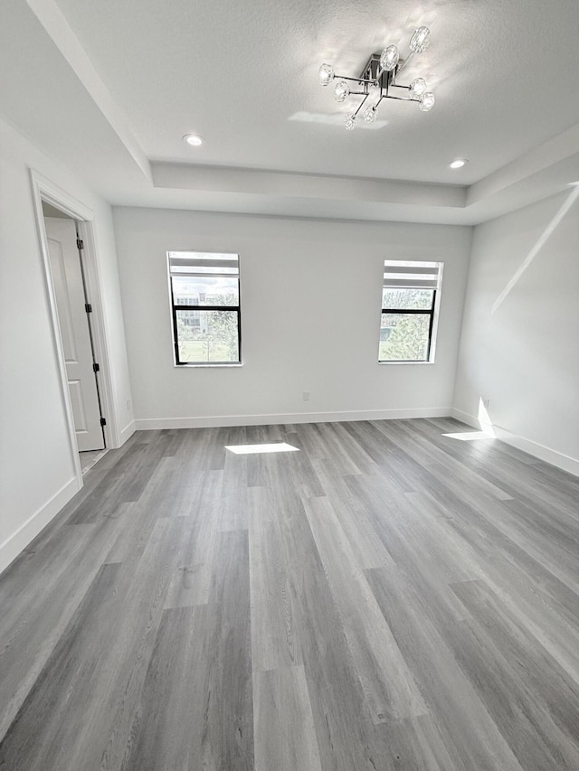 empty room featuring a textured ceiling and hardwood / wood-style flooring