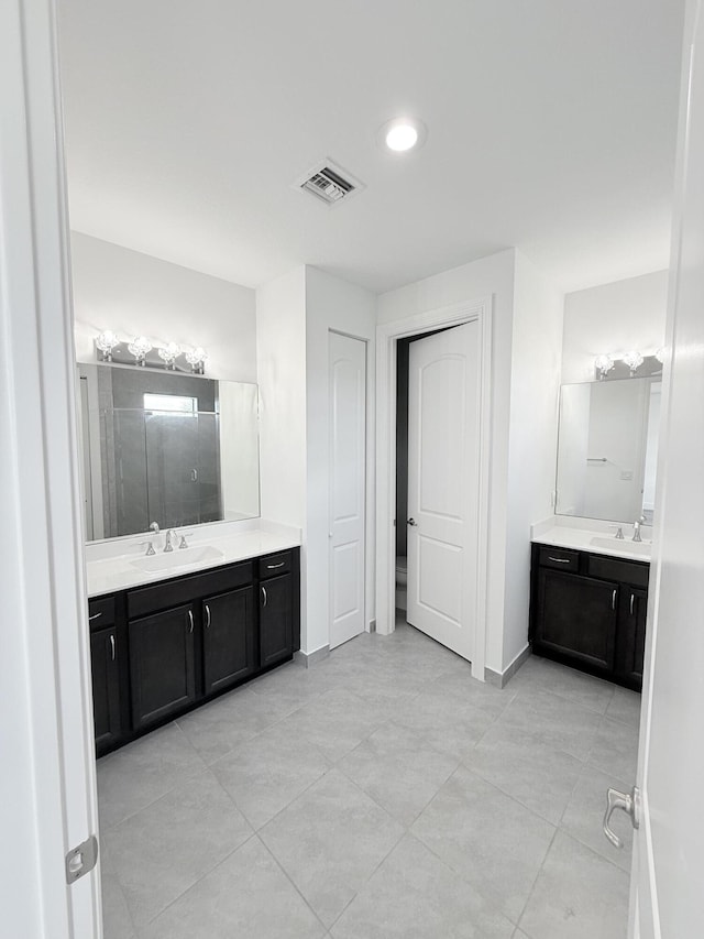 bathroom with vanity, tile patterned floors, and walk in shower