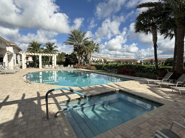 view of pool featuring a patio area, a community hot tub, and a pergola