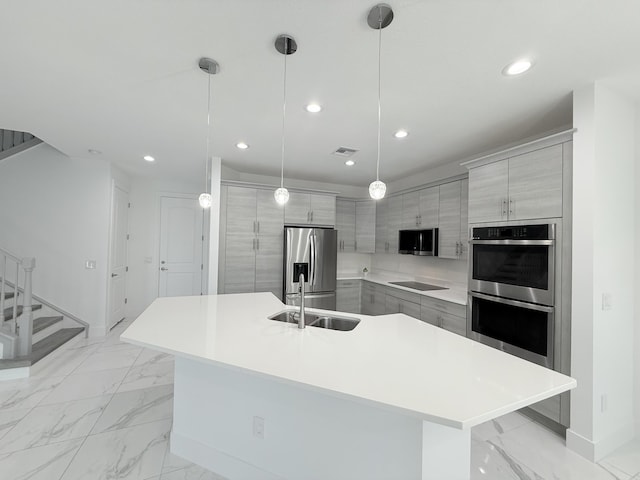 kitchen with a spacious island, hanging light fixtures, gray cabinets, and stainless steel appliances