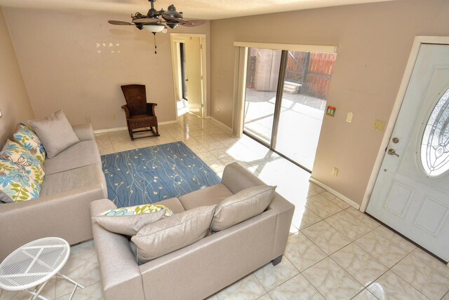 tiled living room with ceiling fan