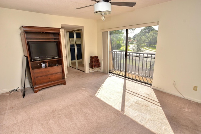 carpeted living room with ceiling fan