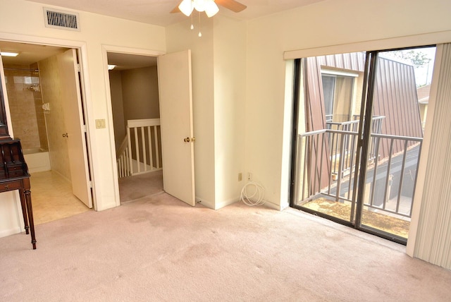 carpeted spare room with ceiling fan