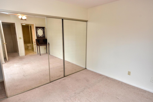 unfurnished bedroom featuring carpet floors and a closet