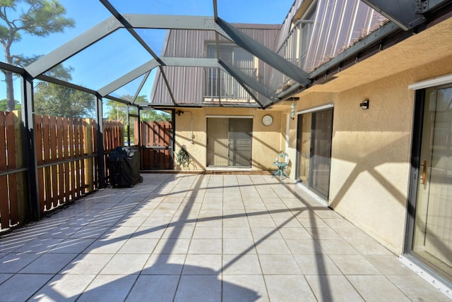 view of patio featuring a lanai