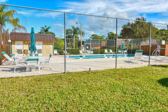 view of pool featuring a patio and a lawn