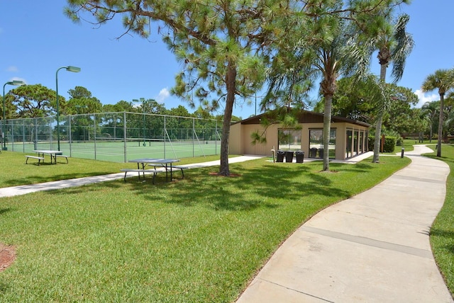 surrounding community with a yard and tennis court