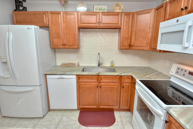 kitchen with backsplash, light tile patterned flooring, white appliances, and sink