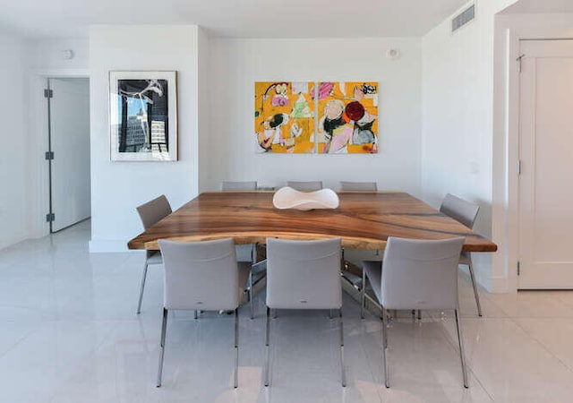 unfurnished dining area featuring light tile patterned floors