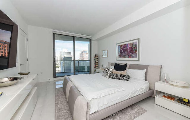 bedroom featuring access to outside and a wall of windows