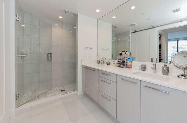 bathroom with tile patterned floors, vanity, and a shower with shower door