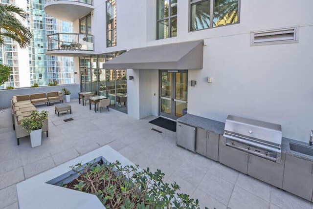 view of patio featuring grilling area, sink, and exterior kitchen