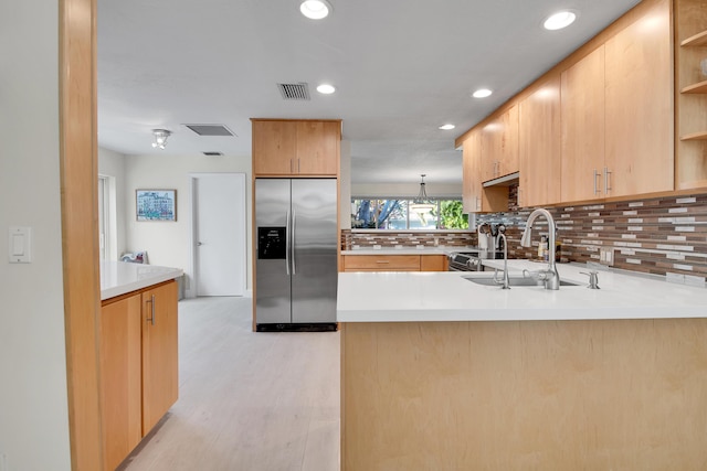 kitchen with kitchen peninsula, built in refrigerator, sink, and light brown cabinetry