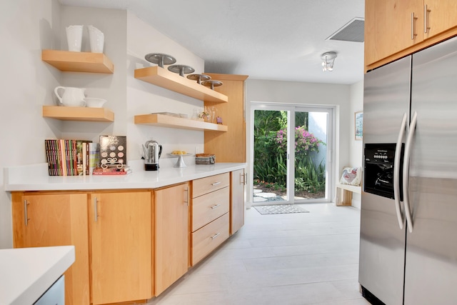 kitchen featuring stainless steel fridge and light brown cabinets