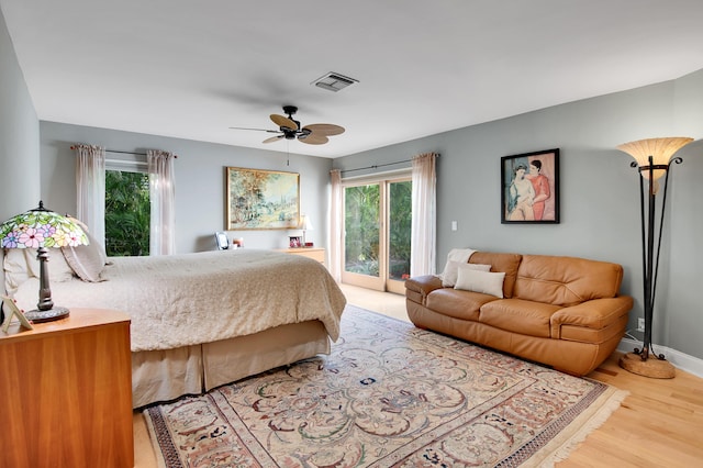 bedroom featuring ceiling fan, access to exterior, and wood-type flooring