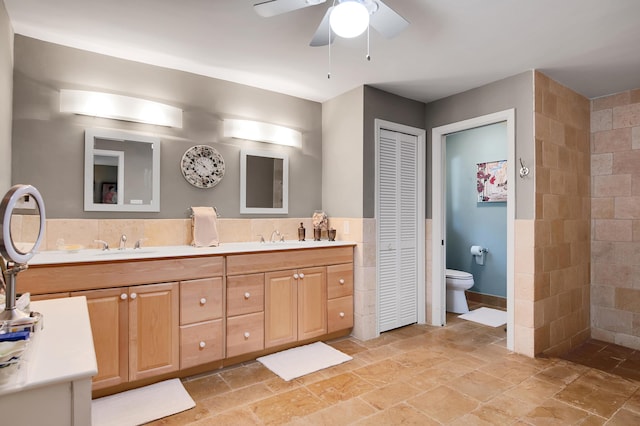 bathroom featuring vanity, ceiling fan, and toilet