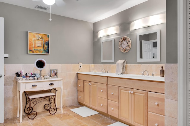 bathroom with vanity, tile walls, and ceiling fan