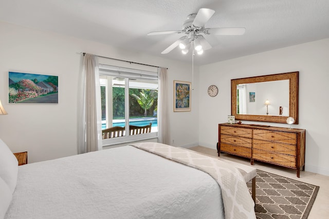 bedroom with access to exterior, a textured ceiling, and ceiling fan