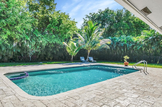 view of swimming pool featuring an in ground hot tub and a patio