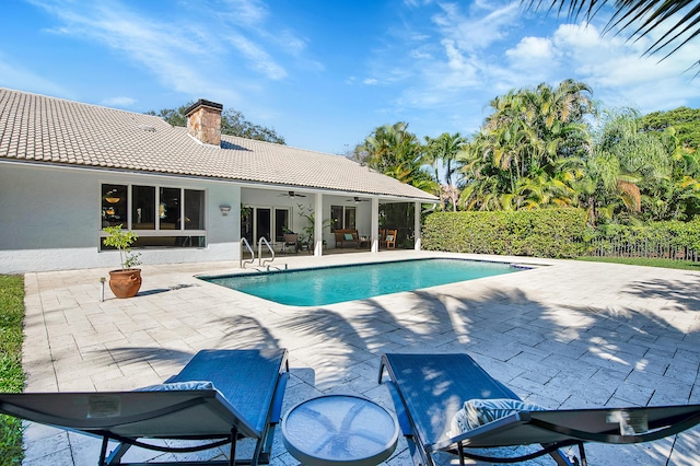 view of pool with ceiling fan and a patio