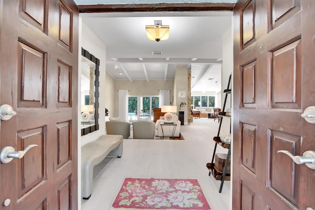 foyer with lofted ceiling with beams