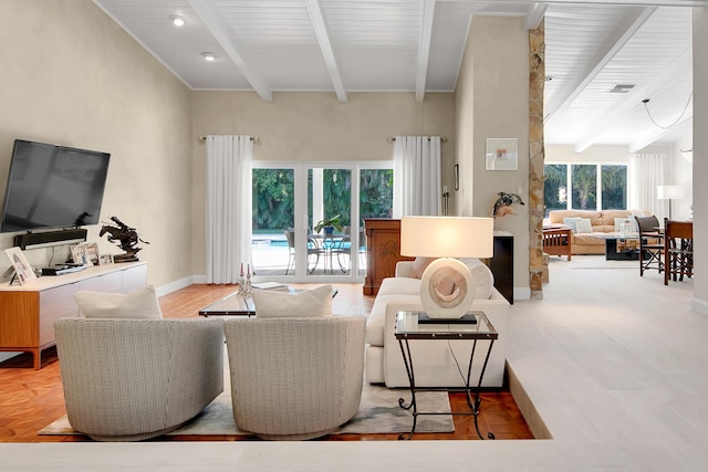 living room with beamed ceiling and a high ceiling