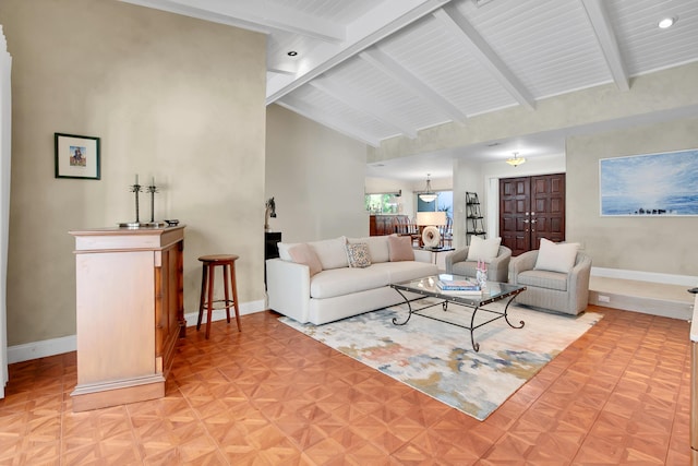 living room with vaulted ceiling with beams and light parquet floors