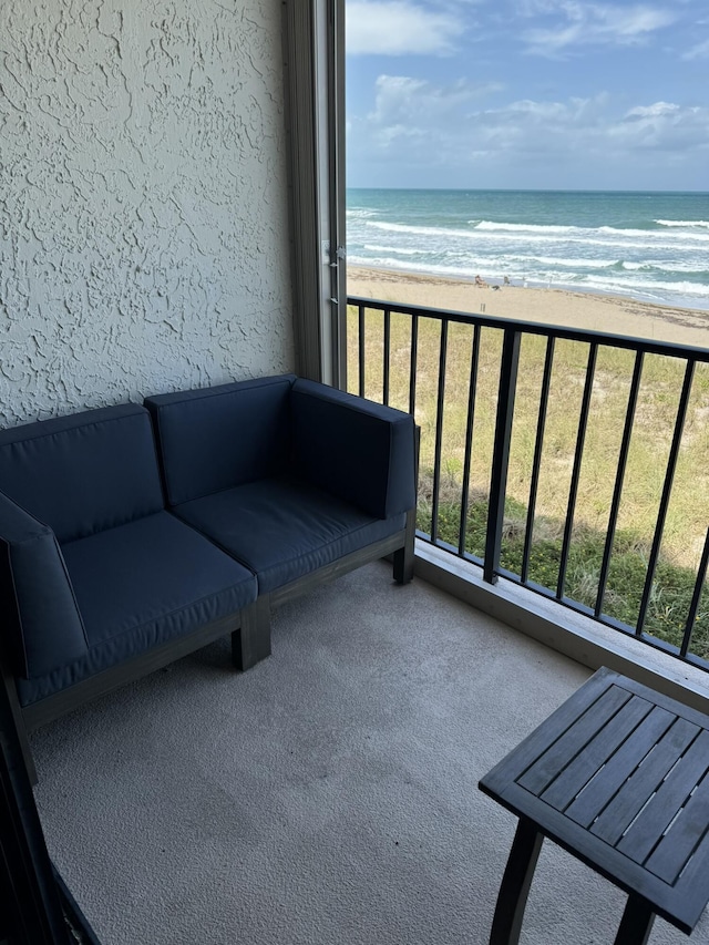 balcony with a view of the beach and a water view