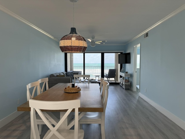 dining room with crown molding, ceiling fan, and dark wood-type flooring