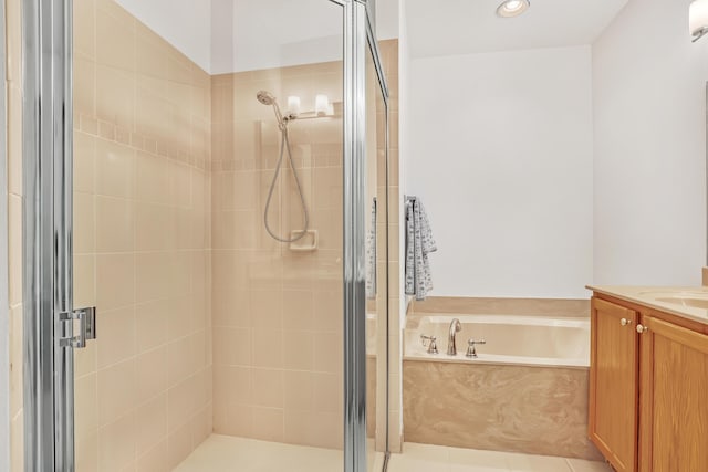 bathroom featuring vanity, tile patterned flooring, and plus walk in shower