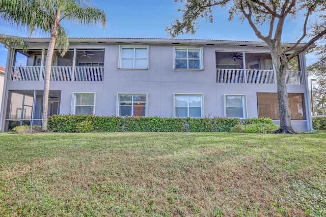 view of property exterior with ceiling fan and a yard