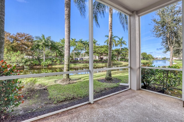 unfurnished sunroom with a water view