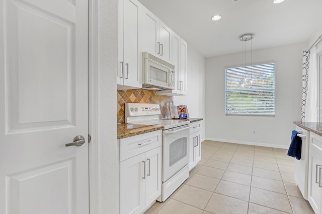 kitchen featuring white cabinets, decorative backsplash, white appliances, and dark stone countertops