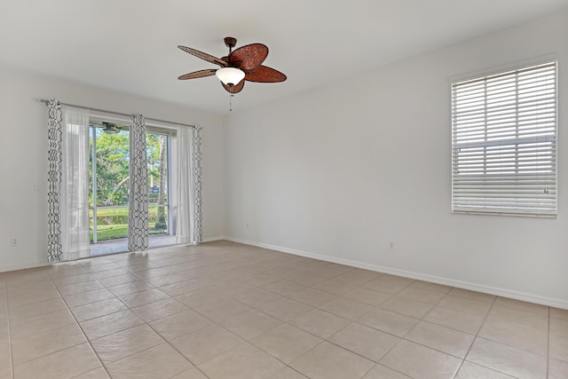 tiled spare room featuring ceiling fan