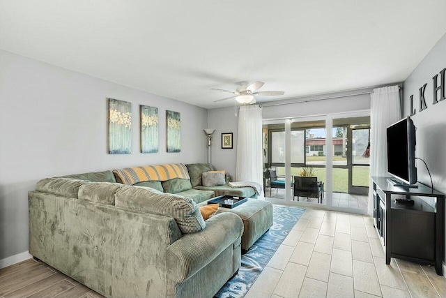 living room featuring ceiling fan and light hardwood / wood-style floors