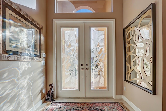 doorway to outside with light tile patterned floors and french doors