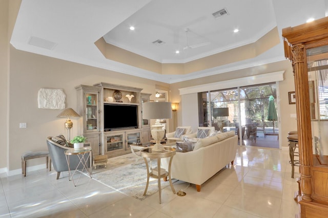 living room featuring a tray ceiling, ceiling fan, crown molding, and light tile patterned flooring