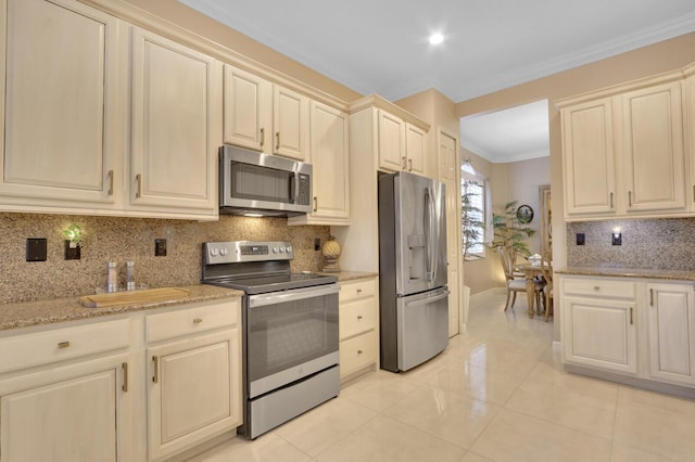 kitchen featuring light stone countertops, appliances with stainless steel finishes, tasteful backsplash, crown molding, and light tile patterned floors