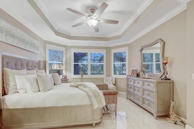 bedroom featuring a tray ceiling, ceiling fan, and crown molding